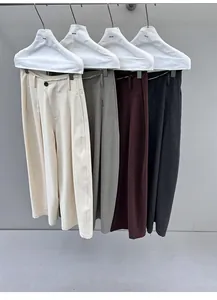 Detail view of four colors of women's floor-length wide-leg trousers on hangers.