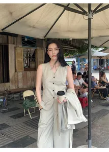 Casual beige high-waist wide-leg pants and vest set styled in outdoor street setting