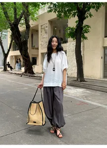 Full-length street shot of women's grey Lyocell Tencel lantern wide-leg trousers