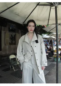 Asian model wearing minimalist beige wide-leg trousers in an outdoor cafe setting