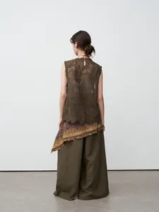 Elegant back view of a woman wearing olive green wide-leg tencel linen casual trousers
