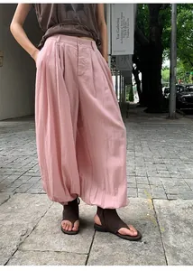 Detail showing the fit and texture of pink Lyocell Tencel wide-leg harem pants
