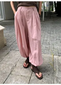 Close-up detail of pink lyocell tencel lantern pants with pleated high waist design