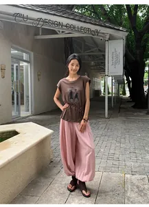 Stylish women's pink Lyocell Tencel lantern wide-leg pants in an outdoor fashion setting