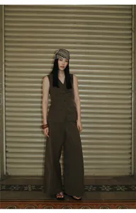 Woman wearing olive brown minimalist cotton-blend vest and wide-leg trousers set