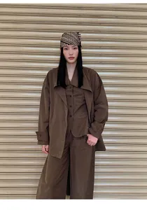 Full look of woman in minimalist brown cotton-nylon high-waist wide-leg trousers.