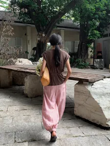 Elegant women's pink lyocell Tencel casual lantern wide-leg trousers in a natural garden