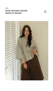 Korean style grey oversized hooded sweatshirt worn by a model in a bright interior