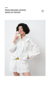 Modern women's white hooded sun protection jacket and shorts set with zipper closure