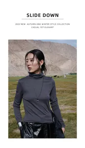 Detalle de camiseta de cuello alto de lana tencel gris oscuro con collar de colgante pequeño