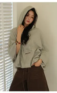 A model wearing an oversized grey hooded sweatshirt with INNOVATE graphic print