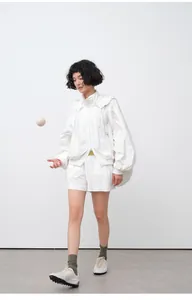 Professional studio full body shot of women's white lightweight hooded sun protection set