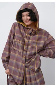 Close-up of a purple and yellow plaid hooded shirt jacket with drawstrings and pockets