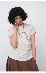 Detail view of a slim-fit beige short sleeve T-shirt with necklace on Asian model