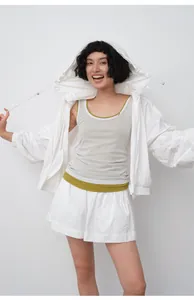 Asian model showcasing a lightweight white hooded sun protection jacket with shorts.