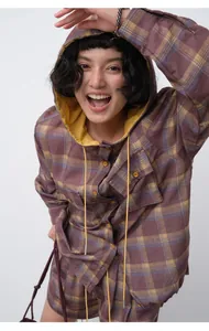 Close-up of lightweight purple and yellow plaid hooded shirt in breathable tencel ramie.