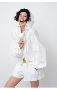 Professional model wearing a lightweight white hooded sun protection jacket with zip closure
