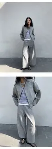Detailed macro view of stylish grey textured zip-up cardigan and wide-leg pants set