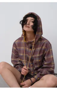 Stylish woman wearing a purple plaid hooded tencel shirt with yellow lining and buttons