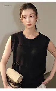 Close-up detail view of a black sleeveless linen-blend knit top on an Asian fashion model