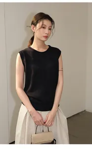 Professional shot of minimalist black sleeveless linen blend knit top on an Asian model