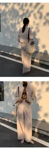 Detailed view of minimalist beige zip-up cardigan and wide-leg pants set for women