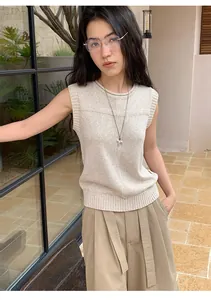 Detailed view of a high-quality beige linen blend sleeveless knit top on a model
