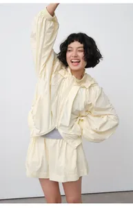 Detailed view of women's lightweight hooded sun-protection jacket in pale yellow