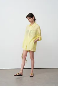 Model wearing a loose, breathable yellow tencel ramie shirt and shorts set for summer