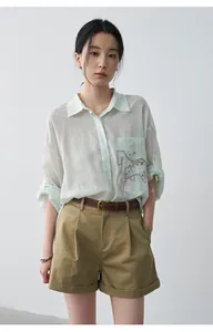 Chic khaki pleated mid-waist shorts with cuffs and brown belt for a summer look