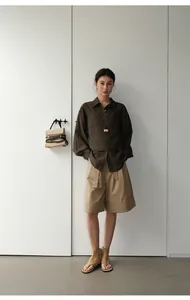 Vista completa de pantalones cortos caqui línea A con elegante detalle vuelto