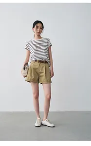 Close-up of stylish khaki high-waisted shorts with pleated front and rolled hem detail
