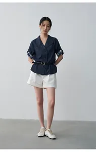 Stylish navy denim shirt with plaid rolled sleeves and a black belt on a model