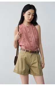 Detailed view of khaki pleated mid-waist cuffed casual shorts for women