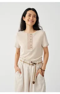 Model wearing a Tencel linen blend knit short sleeve T-shirt with button placket