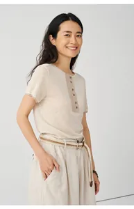 Close-up of a women's beige Tencel linen blend knitted T-shirt with buttoned collar