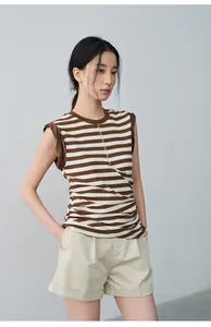 Women's casual pleated beige shorts with cuffed hems for a relaxed summer look.
