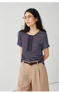 Casual woman wearing a navy and white striped Tencel linen knit T-shirt with buttons