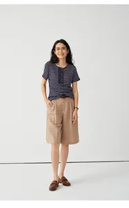 Full body view of woman in striped Tencel linen blend t-shirt and khaki shorts