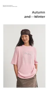 Model wearing a pink round neck knit top with silver jacquard and half sleeves