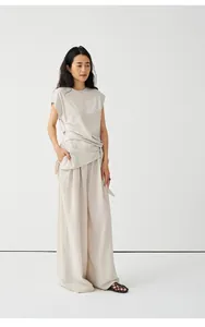 Elegantes minimalistisches beige Strick-T-Shirt mit Taillenband und weiter Hose für Damen.