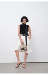 Vue en pied d'un mannequin portant un bermuda d'été blanc minimaliste à jambes larges