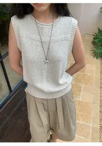 Close-up detail of a beige linen blend sleeveless knit vest with a ribbed crew neck design