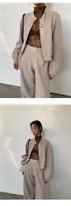 Stylish beige short zip-up sweatshirt and matching lounge trousers set on an Asian model