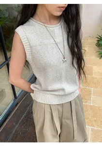 Detail view of a beige linen blend sleeveless knit vest featuring a subtle textured pattern.