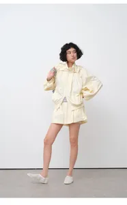 Full view of a women's lightweight hooded sun protection jacket and shorts set in pale yellow.