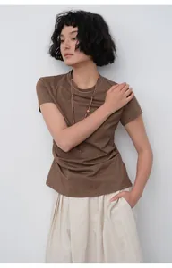 Model wearing a slim-fit brown cotton t-shirt with a stylish necklace accessory detail