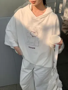 Comfortable oversized white hoodie featuring a unique apple print and innovate text