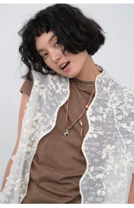 Detail shot of Korean style slim brown T-shirt paired with white lace vest.