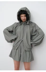 Close-up of loose lightweight hooded sun protection jacket in sage green